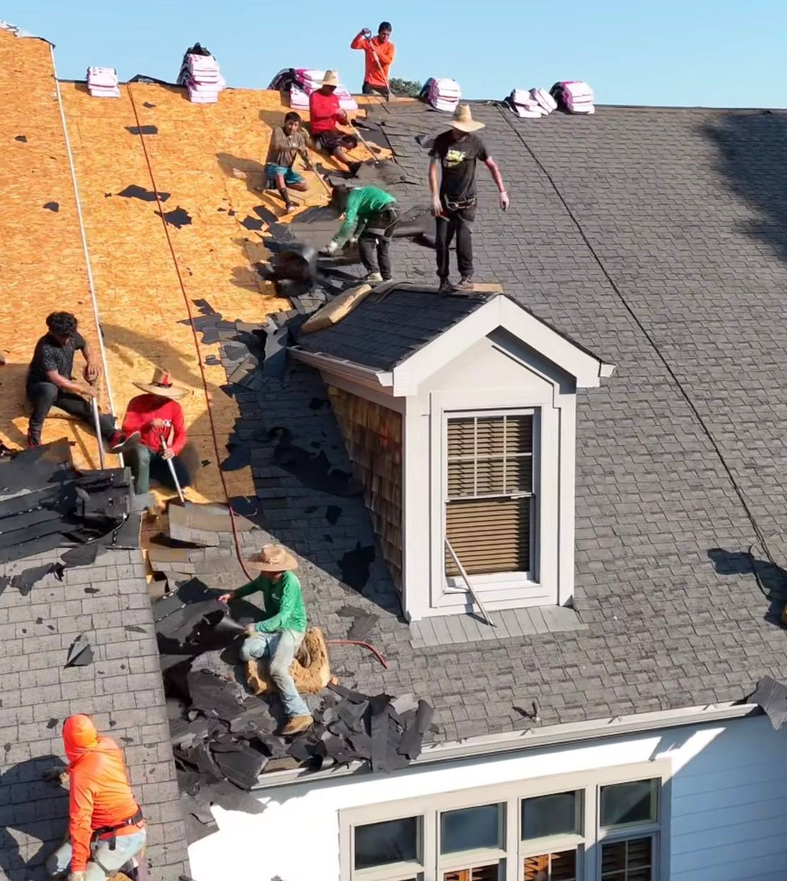 Roofing crew installing new shingles
